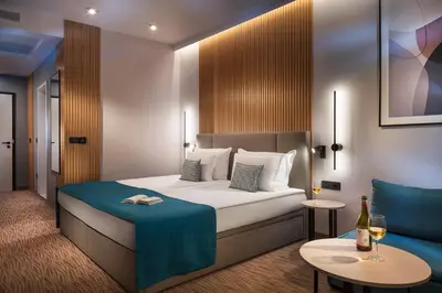 a hotel room with a bed and a couch at Park & Spa Hotel Markovo in Plovdiv