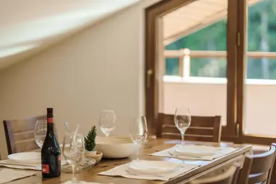 a table with glasses and a bottle of wine at Musala Hotel in Borovets