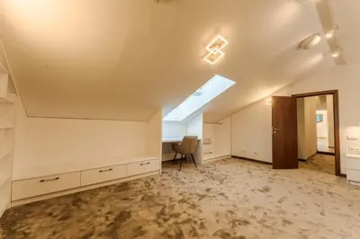 an attic room with a desk and a window at Musala Hotel in Borovets