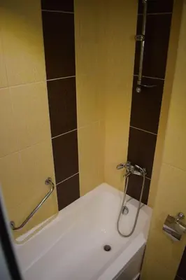 a bathroom with a bath tub with a shower at Slavyanska Beseda Hotel in Sofia