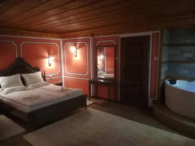 a bedroom with a bed and a bath tub at Once upon a time in Koprivshtitsa