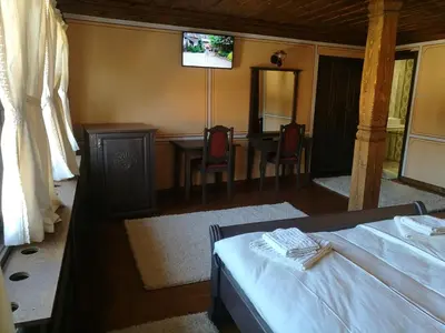 a bedroom with a bed and a table and a television at Once upon a time in Koprivshtitsa