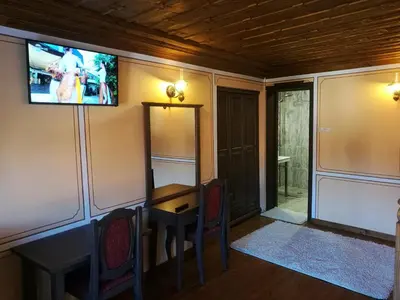 a room with a table and a tv on the wall at Once upon a time in Koprivshtitsa