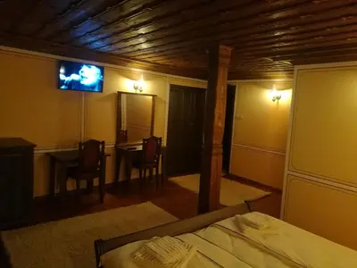 a bedroom with a bed and a tv on the wall at Once upon a time in Koprivshtitsa