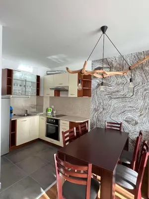 a kitchen with a table and chairs in a room at Local Stay Hotel, BW Signature Collection in Bansko