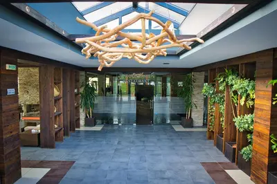 a large lobby with a chandelier hanging from the ceiling at Local Stay Hotel, BW Signature Collection in Bansko