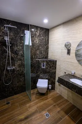 a bathroom with a shower and a toilet and a sink at Hotel Montecito in Sofia