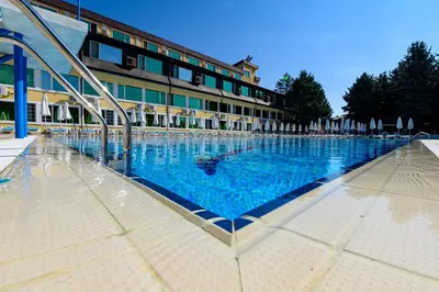 a large swimming pool in front of a building at Hotel Montecito in Sofia