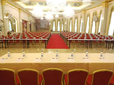 a large hall with tables and chairs with water bottles on them at Hotel Montecito in Sofia