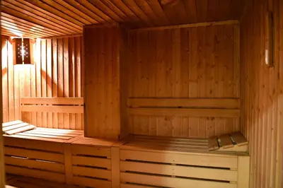 a wooden sauna with a bench in it at Hotel Bojur & Bojurland Apartment Complex in Bansko