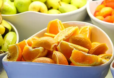 a blue bowl filled with oranges and other fruit at Victoria Hotel Borovets - Free Parking in Borovets