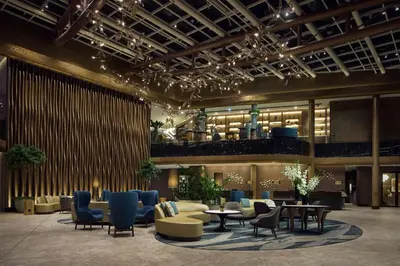 a lobby with couches and chairs and a table at Hilton Sofia in Sofia