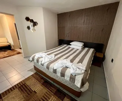 a bedroom with a bed with towels on it at ALPHA family HOTEL in Blagoevgrad