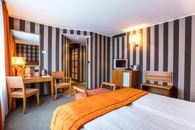 a hotel room with a bed and a desk at Eurostars Sofia City in Sofia