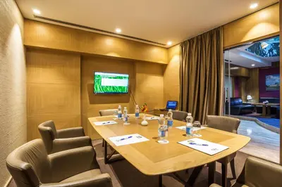 a conference room with a large wooden table and chairs at Eurostars Sofia City in Sofia