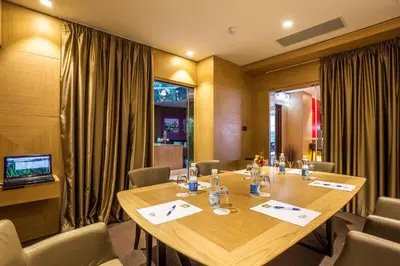 a conference room with a large wooden table and chairs at Eurostars Sofia City in Sofia
