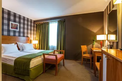 a hotel room with a bed and a desk at Eurostars Sofia City in Sofia