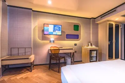 a bedroom with a bed and a desk and a computer at Eurostars Sofia City in Sofia