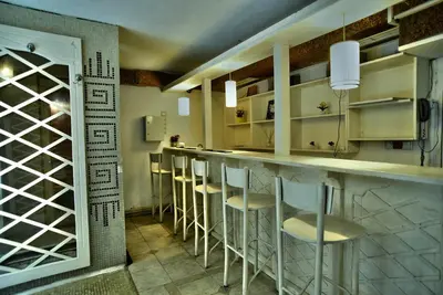 a kitchen with a bar with stools in it at Hotel Friends in Bansko
