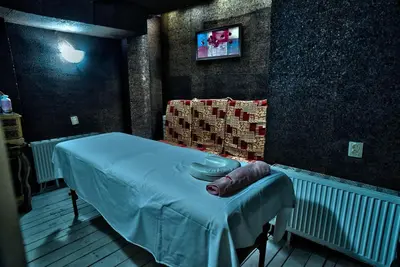 a hospital room with a bed and a tv at Hotel Friends in Bansko