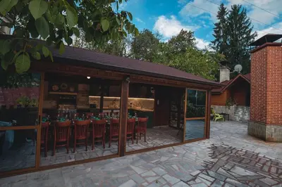 an outdoor patio with a bar with red chairs at Duvaro Guesthouse in Raduil