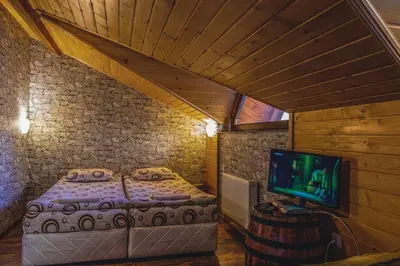 a bedroom with a bed and a tv in a room at Duvaro Guesthouse in Raduil