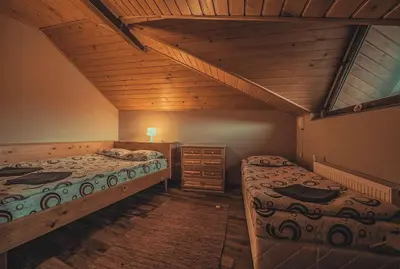 a bedroom with two beds and a wooden ceiling at Duvaro Guesthouse in Raduil