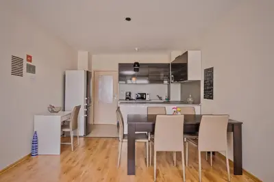 a kitchen and dining room with a table and chairs at Vitosha View One Bedroom Apartment by Flat Mаnager in Sofia