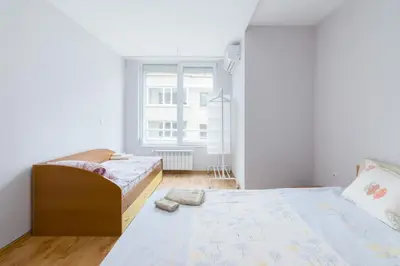 a bedroom with two beds and a window at Vitosha View One Bedroom Apartment by Flat Mаnager in Sofia