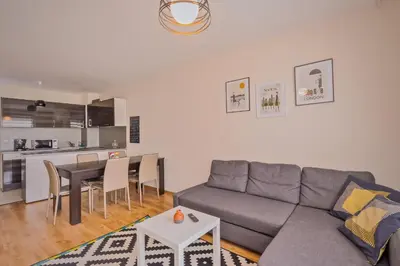 a living room with a couch and a table at Vitosha View One Bedroom Apartment by Flat Mаnager in Sofia