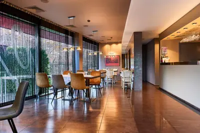 a dining room with a table and chairs at Monet Hotel in Plovdiv