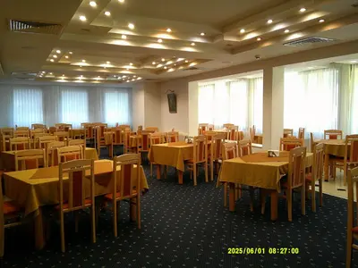 a dining room with tables and chairs at Finlandia Hotel in Pamporovo