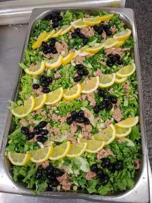 a salad with lemon slices on top of it at Finlandia Hotel in Pamporovo
