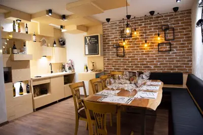 a dining room with a table with wine glasses at The Castle Complex in Pamporovo