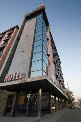 a building with a hotel on top of it at Budapest Hotel - Free Parking in Sofia