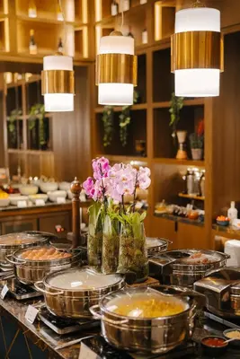 a buffet line with plates of food and flowers at Sofia Balkan Palace in Sofia