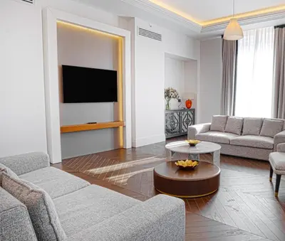 a living room with two couches and a tv at Sofia Balkan Palace in Sofia