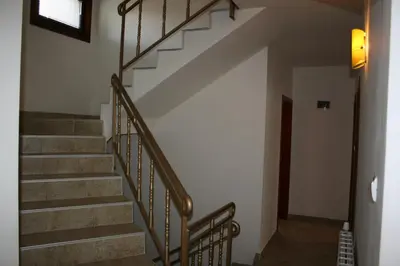 a staircase in a house with a stair railing at Aseva House Guest house in Bansko