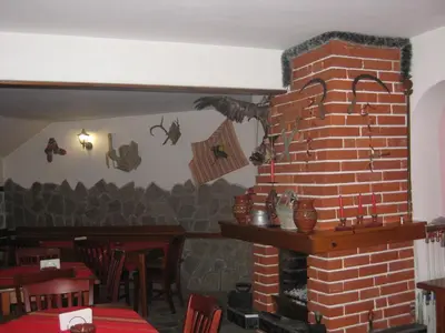 a room with a brick fireplace in a restaurant at Aseva House Guest house in Bansko