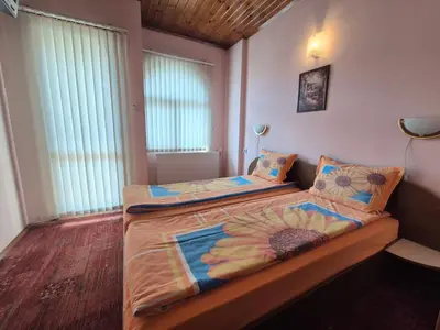 a bedroom with two beds and a window at Aseva House Guest house in Bansko