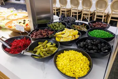 a buffet filled with bowls of different types of food at Vihren Royal Palace in Bansko
