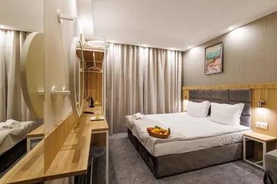 a hotel room with a bed with a bowl of fruit on it at Vihren Royal Palace in Bansko
