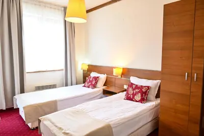 a hotel room with two beds and a window at Vihren Royal Palace in Bansko