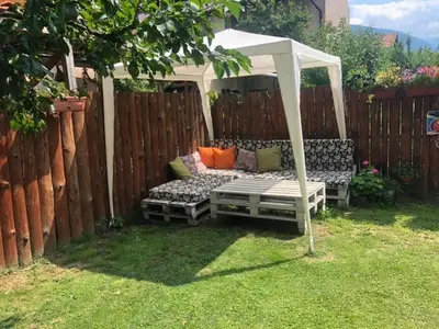 a gazebo with a couch in a backyard at Michel Hotel in Bansko
