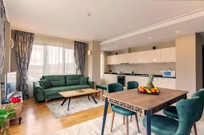 a living room with a green couch and a table at Murite Park Hotel in Bansko