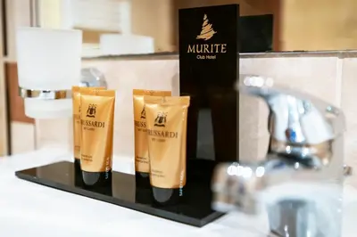 a set of three bottles of moisturizing products on a bathroom counter at Murite Park Hotel in Bansko