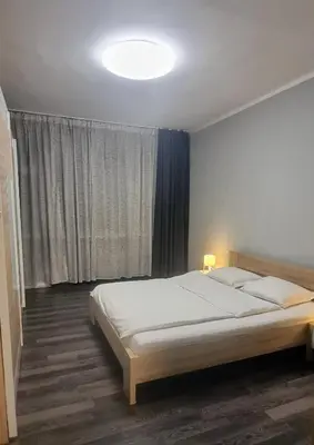 a bedroom with a bed and a large window at Best Choice Apartment in Sofia