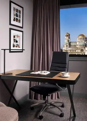 a desk with a chair in front of a window at InterContinental Sofia by IHG in Sofia