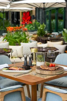 a wooden table with two pizzas and glasses of wine at InterContinental Sofia by IHG in Sofia