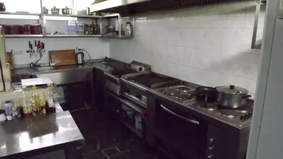 a kitchen with a stove top oven in a kitchen at Villa Filip in Bachevo